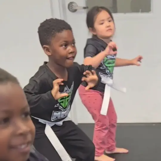 Young students in fighting stance during a kids class
